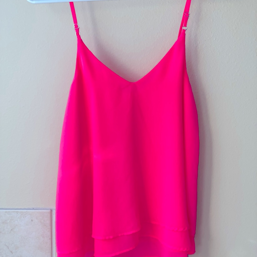Bright pink flowy tank top. Double layer polyester. Hits at hips